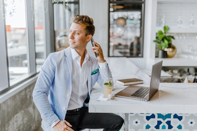 man in suit talking to the phone