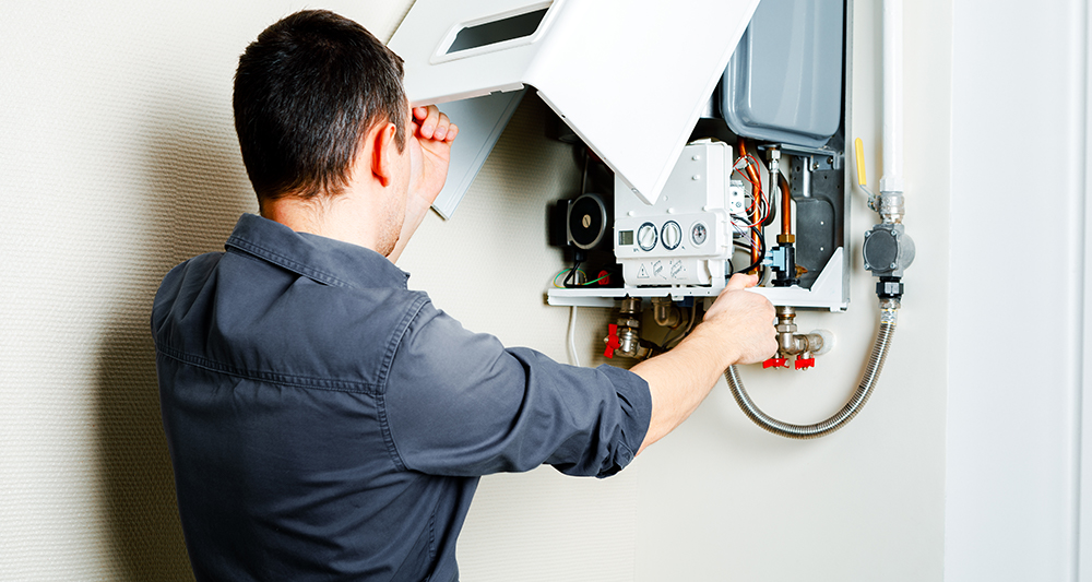 man repairing boiler